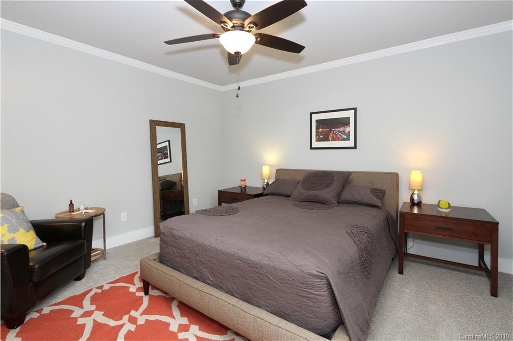 4217 Walker Road Charlotte, NC 28211 - Photo 26 of 34 a spacious bedroom with a bed and furniture