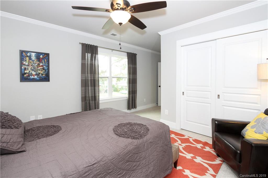 4217 Walker Road Charlotte, NC 28211 - Photo 27 of 34 a bedroom with a bed and a chandelier fan