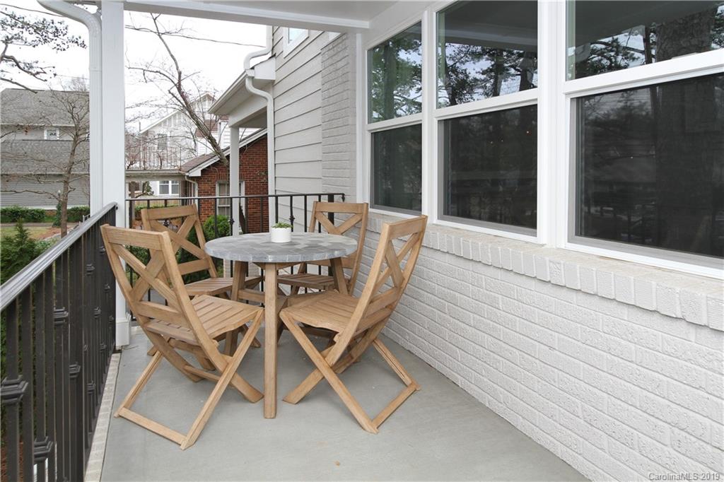 4217 Walker Road Charlotte, NC 28211 - Photo 32 of 34 a patio with a table and chairs and potted plants