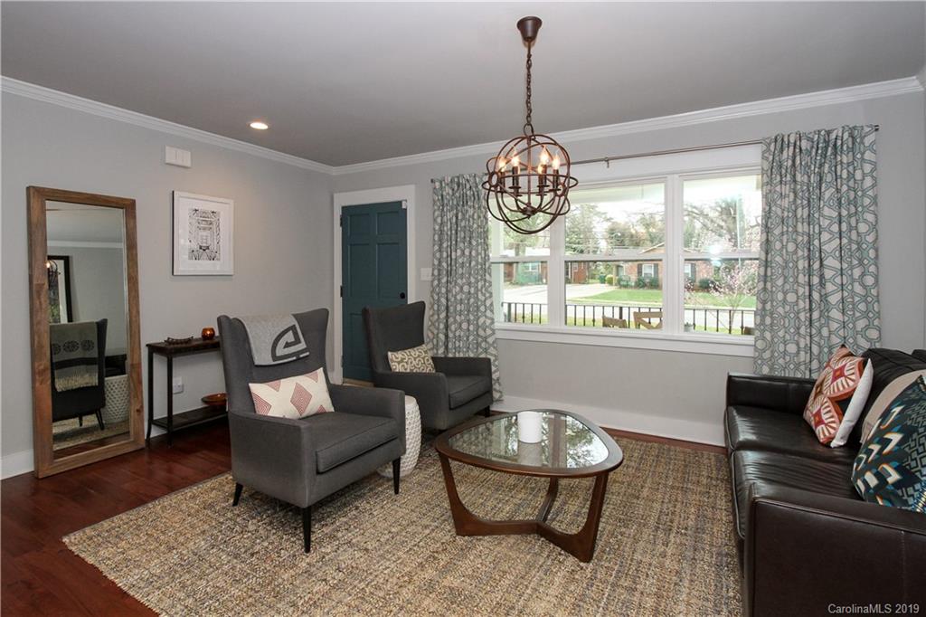 4217 Walker Road Charlotte, NC 28211 - Photo 5 of 34 a living room with furniture and a chandelier