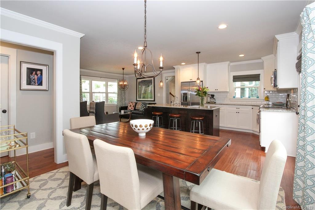 4217 Walker Road Charlotte, NC 28211 - Photo 8 of 34 a dining room with stainless steel appliances kitchen island a table and chairs