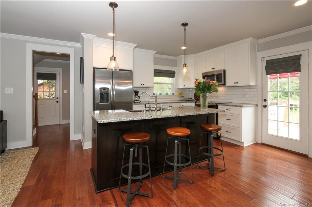 4217 Walker Road Charlotte, NC 28211 - Photo 10 of 34 a kitchen with stainless steel appliances a dining table chairs and sink