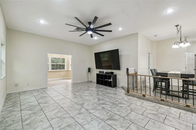 a large white bathroom with a granite countertop sink a toilet and bathtub