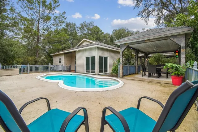 a large kitchen with a stove a sink dishwasher a refrigerator and a oven with wooden floor