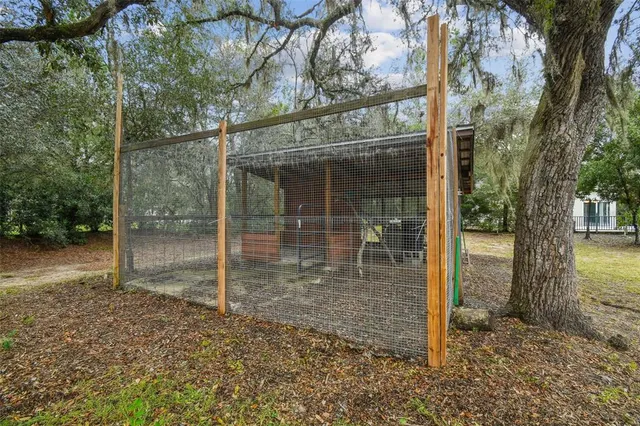 a view of a hallway with wooden floor and a living room