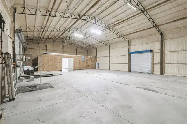 an aerial view of a house with garden space and street view