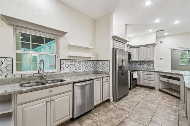 a view of a dining room with furniture and chandelier