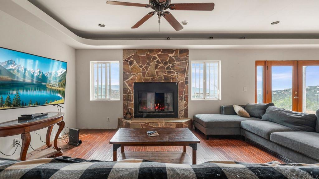 45620 Lewis Valley Road Hemet, CA 92544 - Photo 15 of 53 a living room with furniture flat screen tv and a fireplace