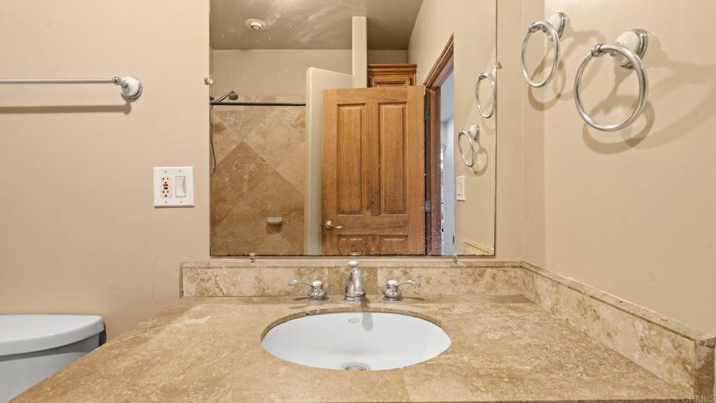 45620 Lewis Valley Road Hemet, CA 92544 - Photo 26 of 53 a bathroom with a sink and a mirror