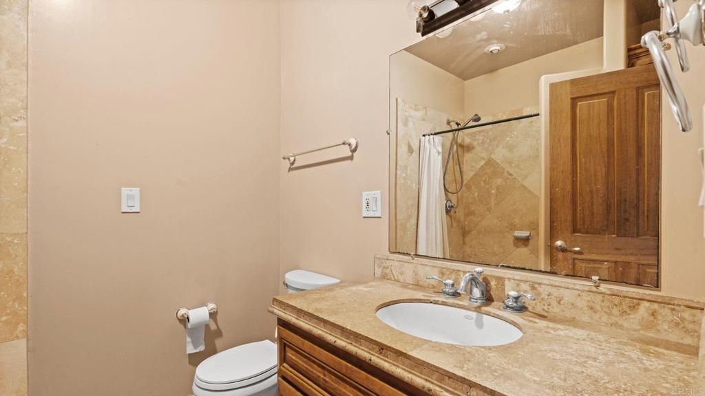 45620 Lewis Valley Road Hemet, CA 92544 - Photo 33 of 53 a bathroom with a granite countertop sink toilet and shower