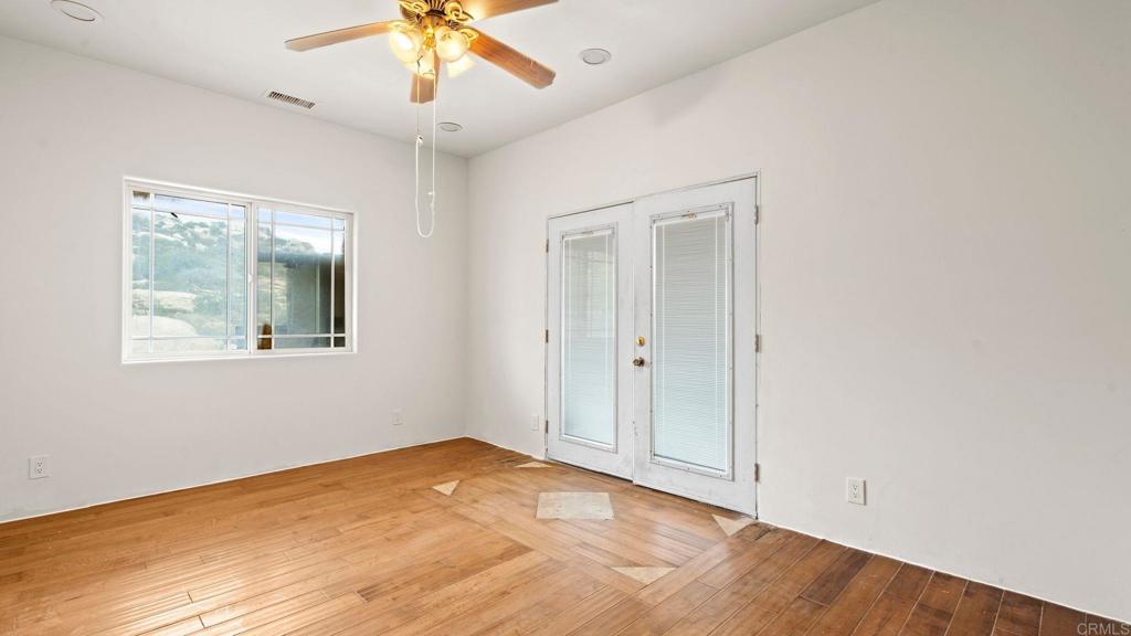 45620 Lewis Valley Road Hemet, CA 92544 - Photo 34 of 53 a view of an empty room with window and wooden floor