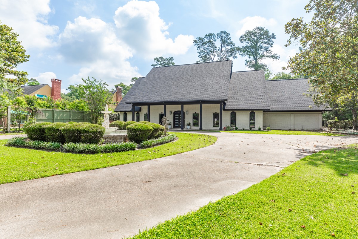 1380 Thomas Road Beaumont, TX 77706 - Photo 1 of 35 a house with green field in front of it