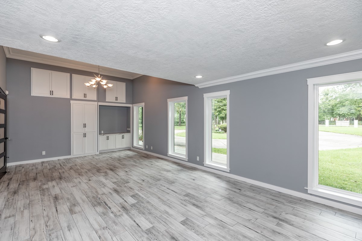 1380 Thomas Road Beaumont, TX 77706 - Photo 19 of 35 a view of an empty room with wooden floor and windows