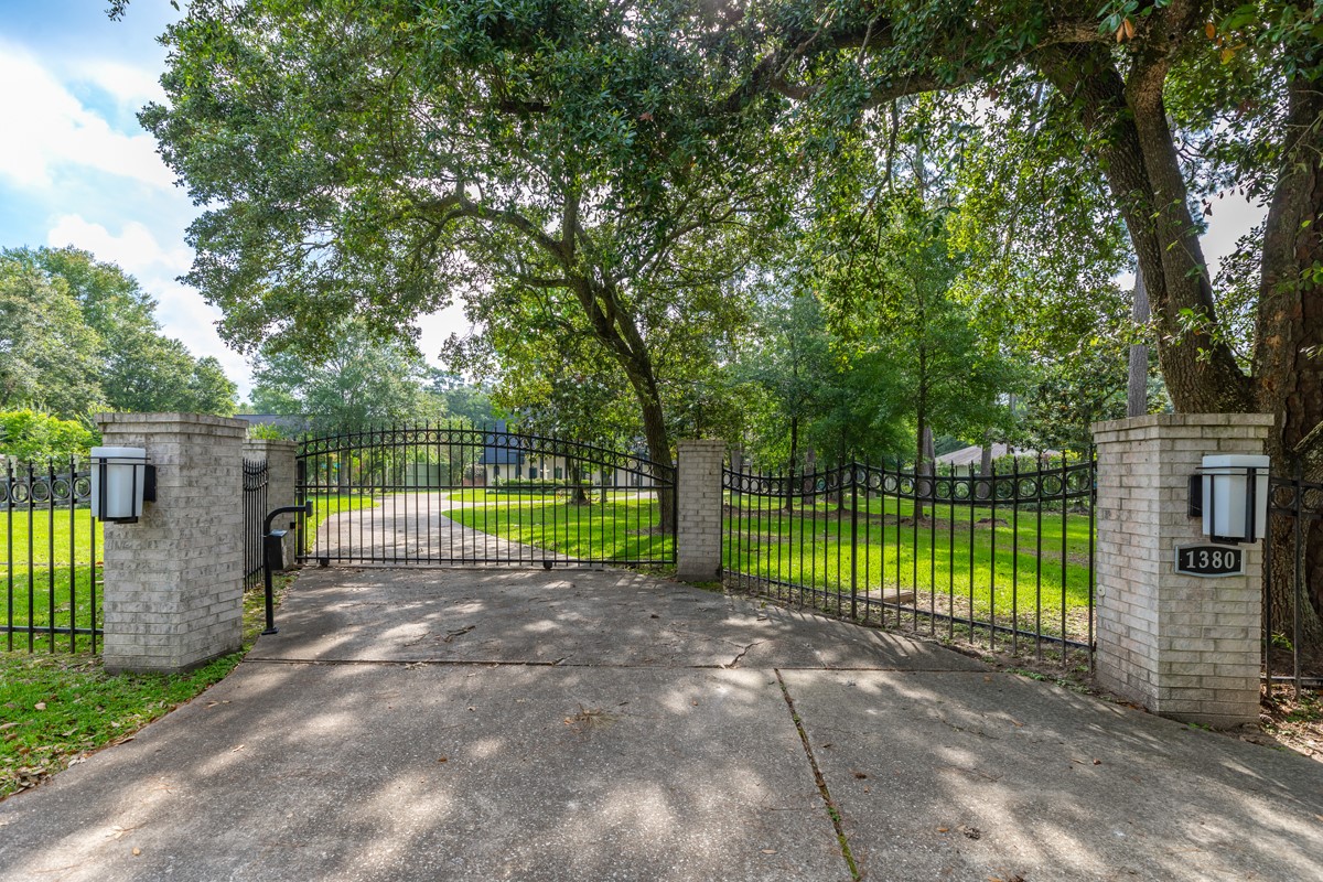 1380 Thomas Road Beaumont, TX 77706 - Photo 2 of 35 a view of a park with large trees and a small yard