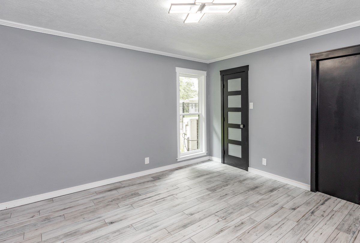 1380 Thomas Road Beaumont, TX 77706 - Photo 28 of 35 a view of an empty room with wooden floor and a window