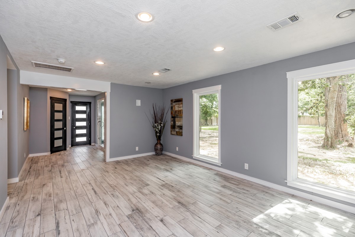 1380 Thomas Road Beaumont, TX 77706 - Photo 29 of 35 a view of an empty room with wooden floor and a window