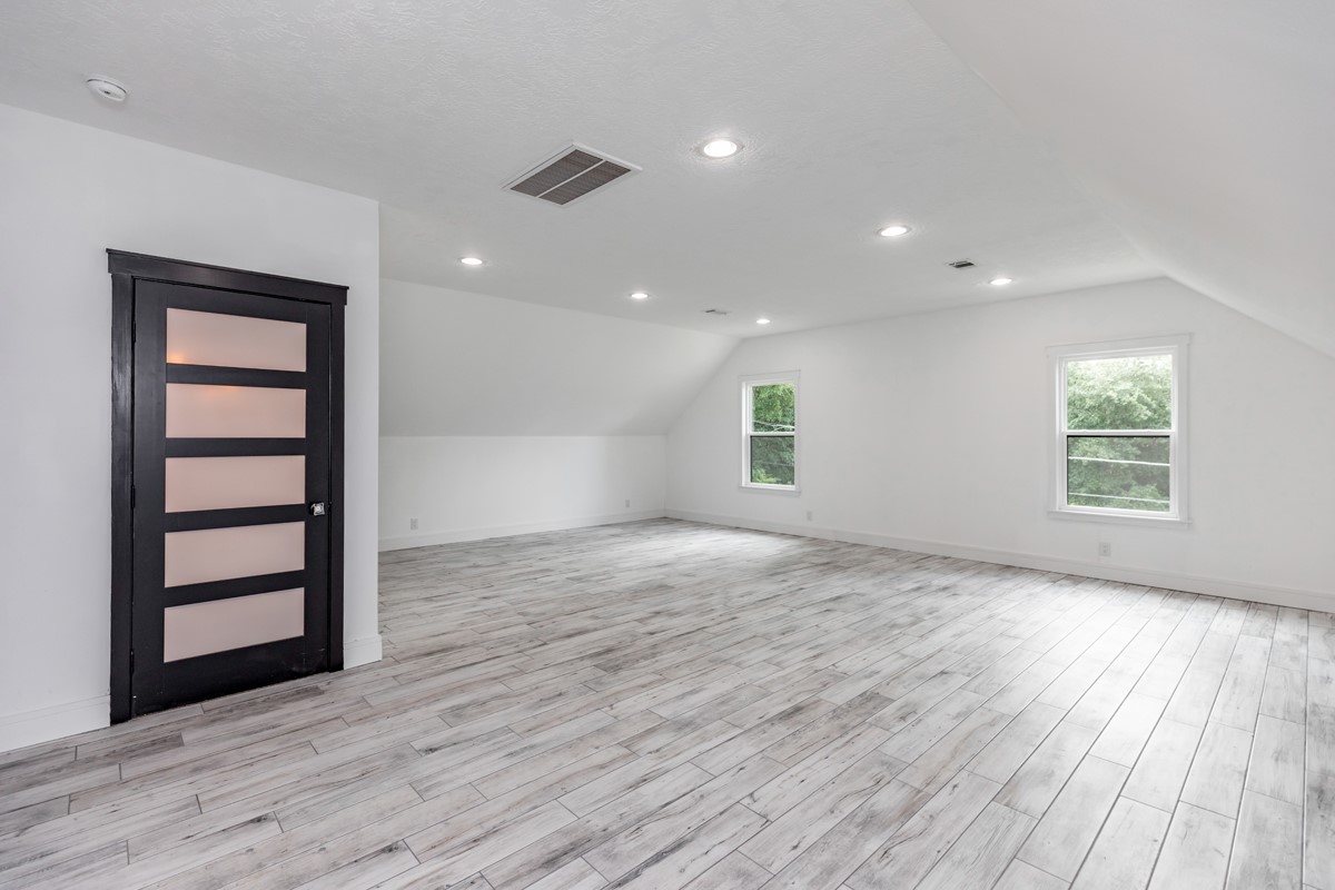 1380 Thomas Road Beaumont, TX 77706 - Photo 32 of 35 an empty room with wooden floor and windows