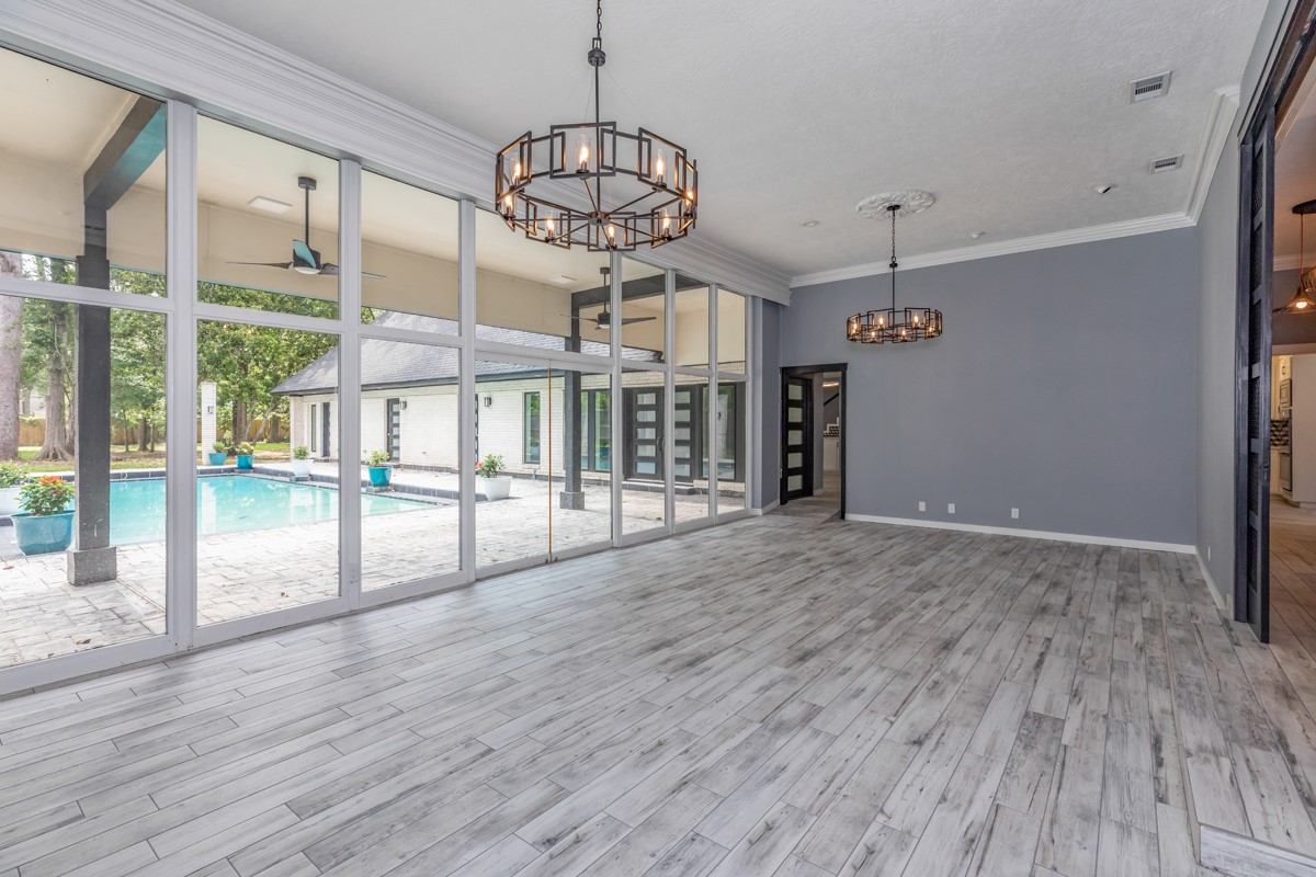 1380 Thomas Road Beaumont, TX 77706 - Photo 8 of 35 a view of a big room with wooden floor and chandelier