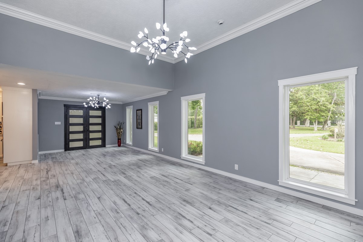 1380 Thomas Road Beaumont, TX 77706 - Photo 9 of 35 a view of an empty room with wooden floor and a window