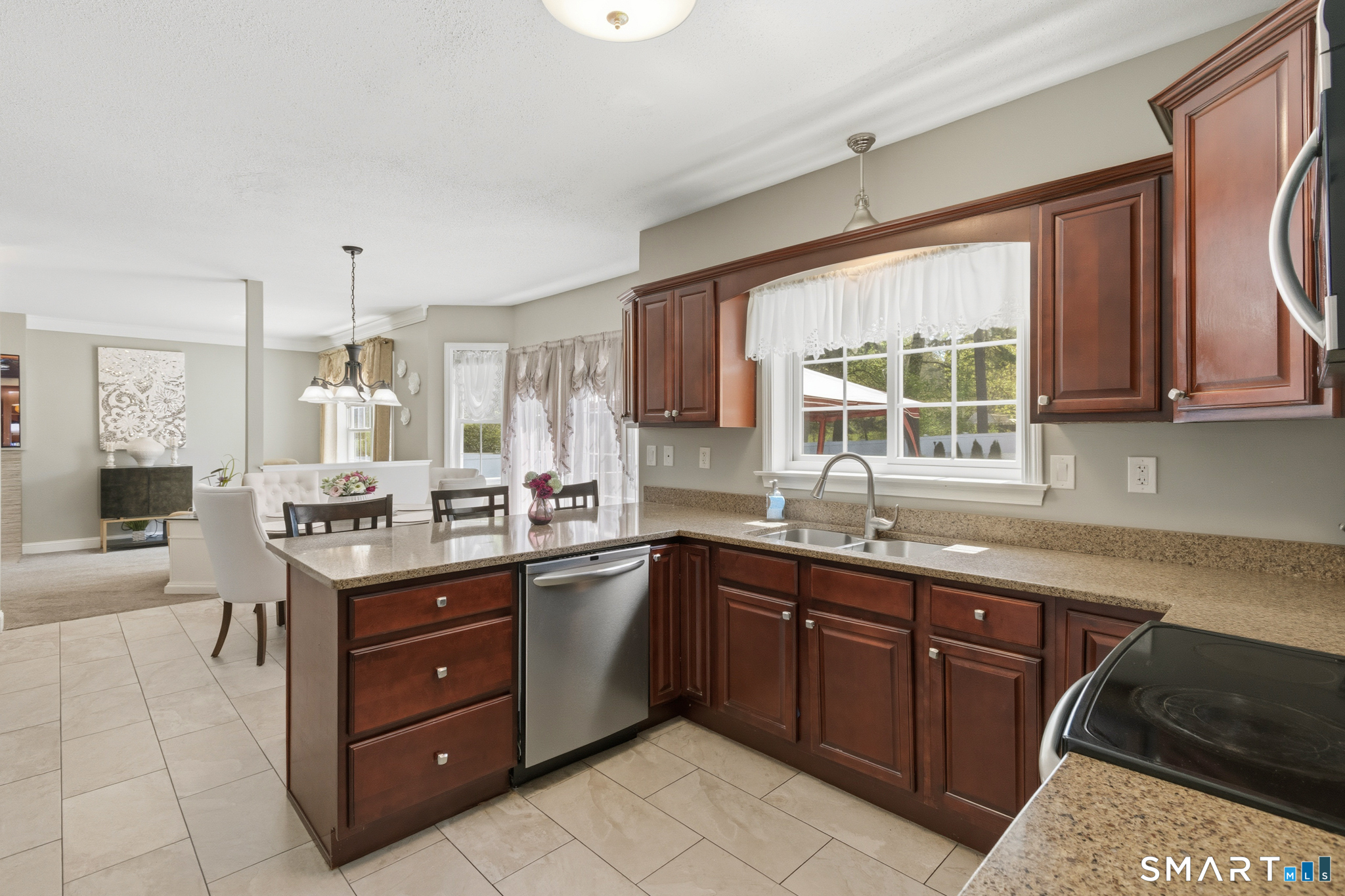5 Ice Pond Road Granby, CT 06035 - Photo 9 of 40 a kitchen with a sink window and cabinets