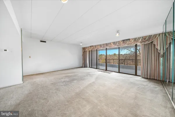 a view of an empty room with a balcony