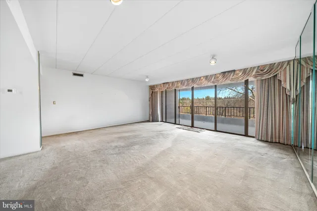 a view of an empty room with a balcony