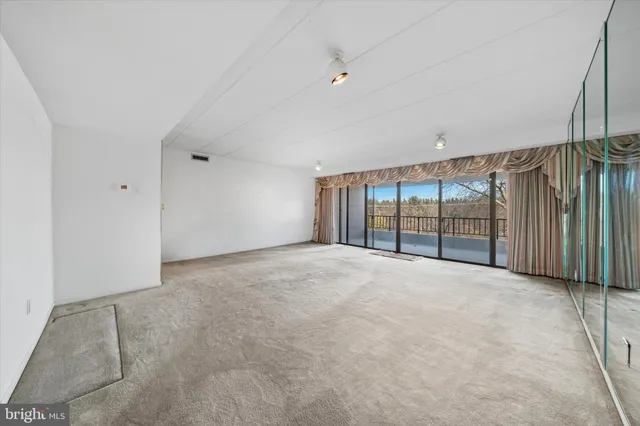 a view of an empty room with a balcony