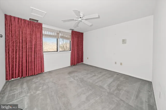 a view of a livingroom with a ceiling fan and window