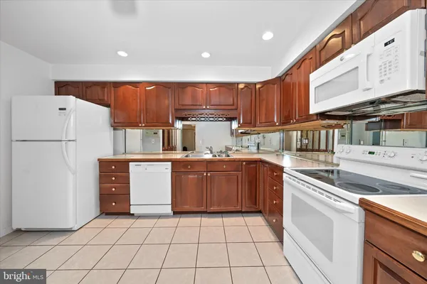 a kitchen with a refrigerator sink and cabinets