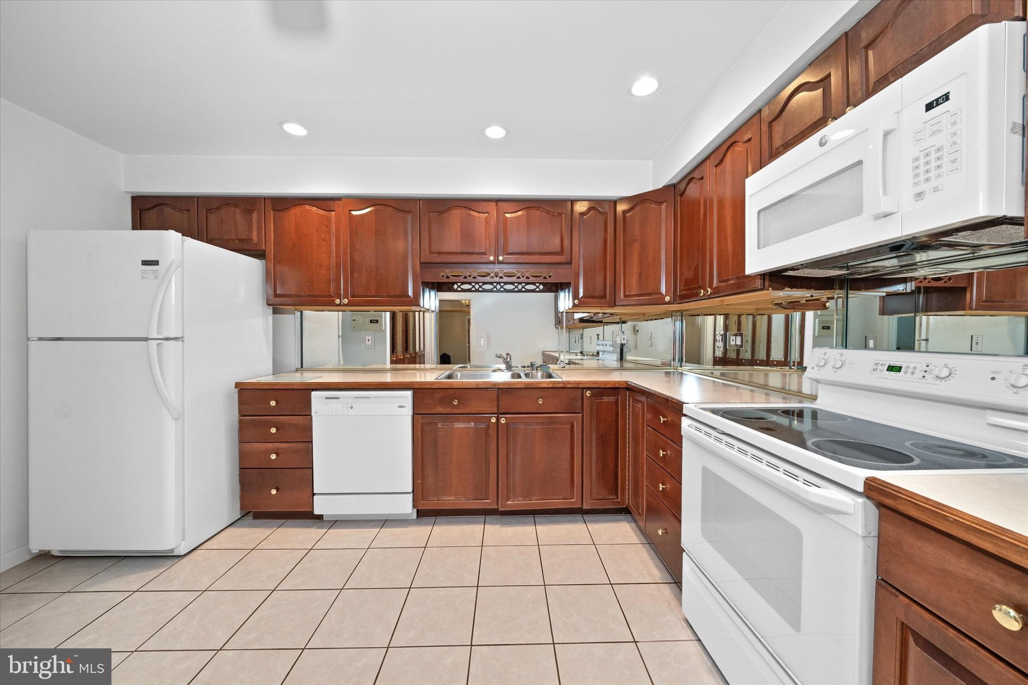 614 Loveville Road, Unit C04H Hockessin, DE 19707 - Photo 5 of 36 a kitchen with a refrigerator sink and cabinets