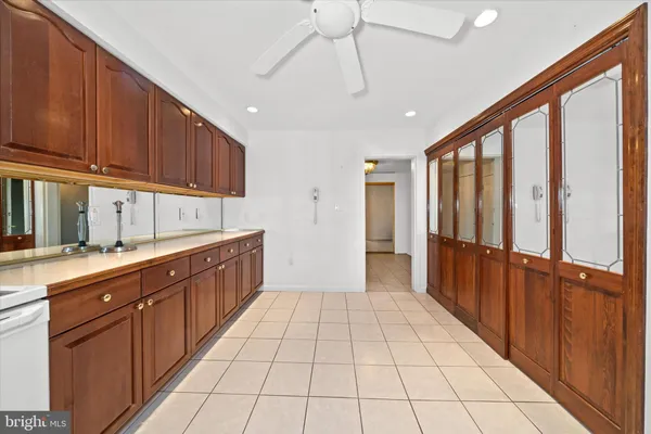 a large kitchen with stainless steel appliances granite countertop a refrigerator a sink dishwasher and wooden cabinets with wooden floor