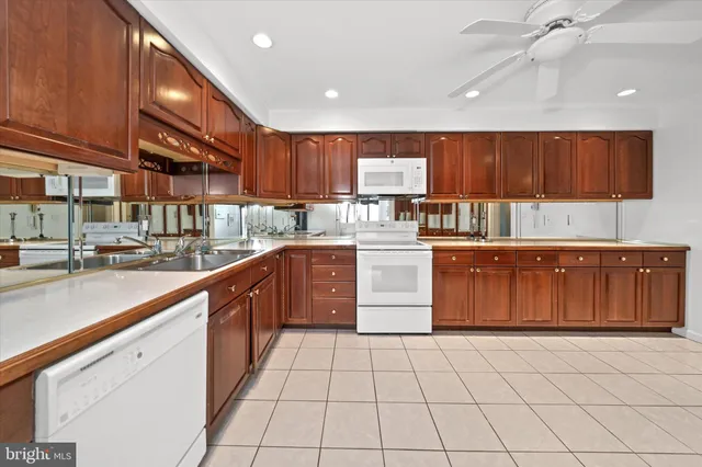a kitchen with a sink a counter space cabinets and appliances