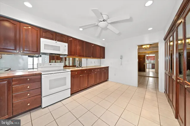 a kitchen with a cabinets and chandelier