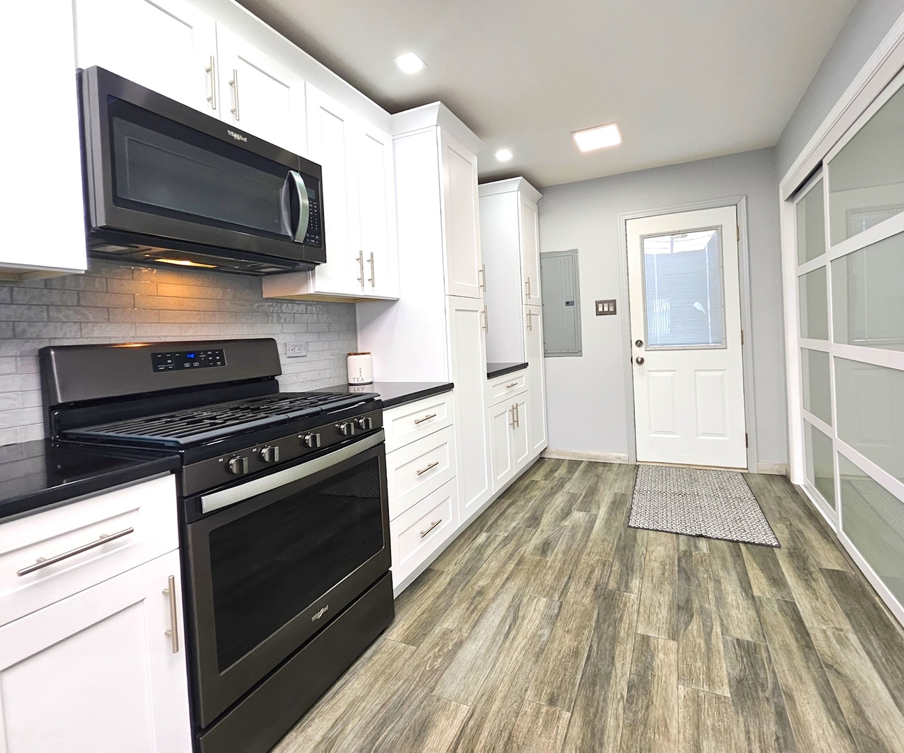 7806 West 83rd Street Bridgeview, IL 60455 - Photo 10 of 53 a kitchen with stainless steel appliances a stove microwave and cabinets