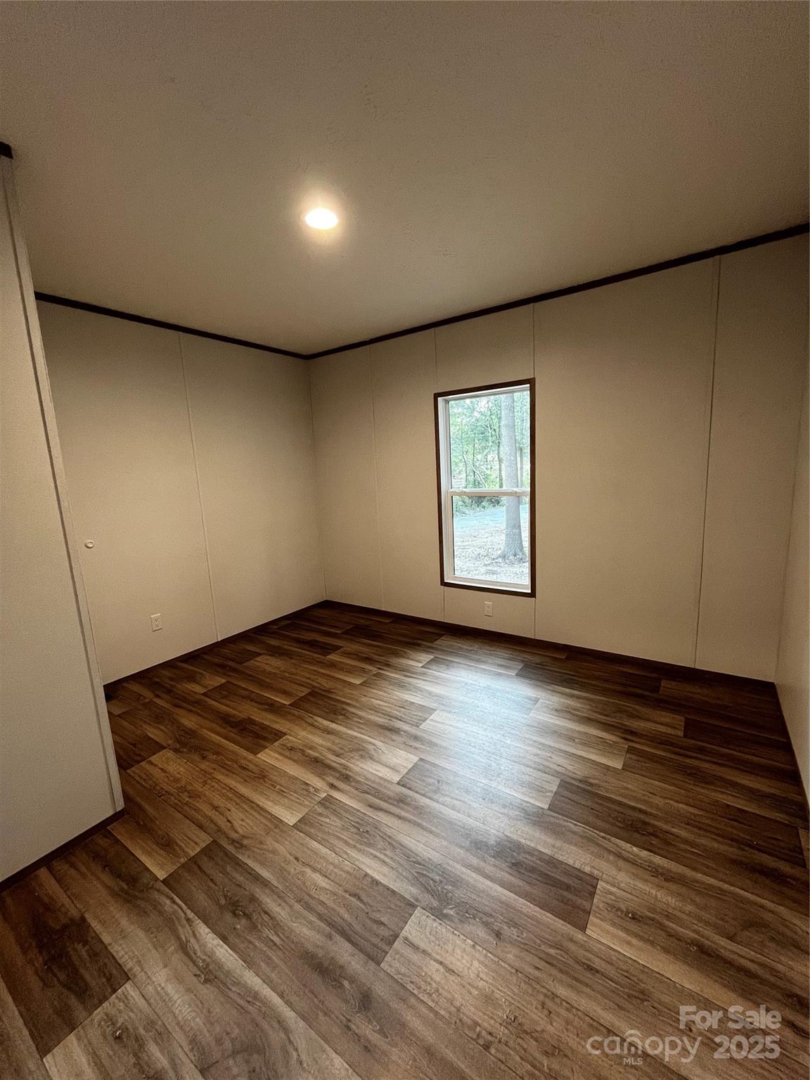181 Duncan Road Pageland, SC 29728 - Photo 11 of 11 an empty room with wooden floor and windows