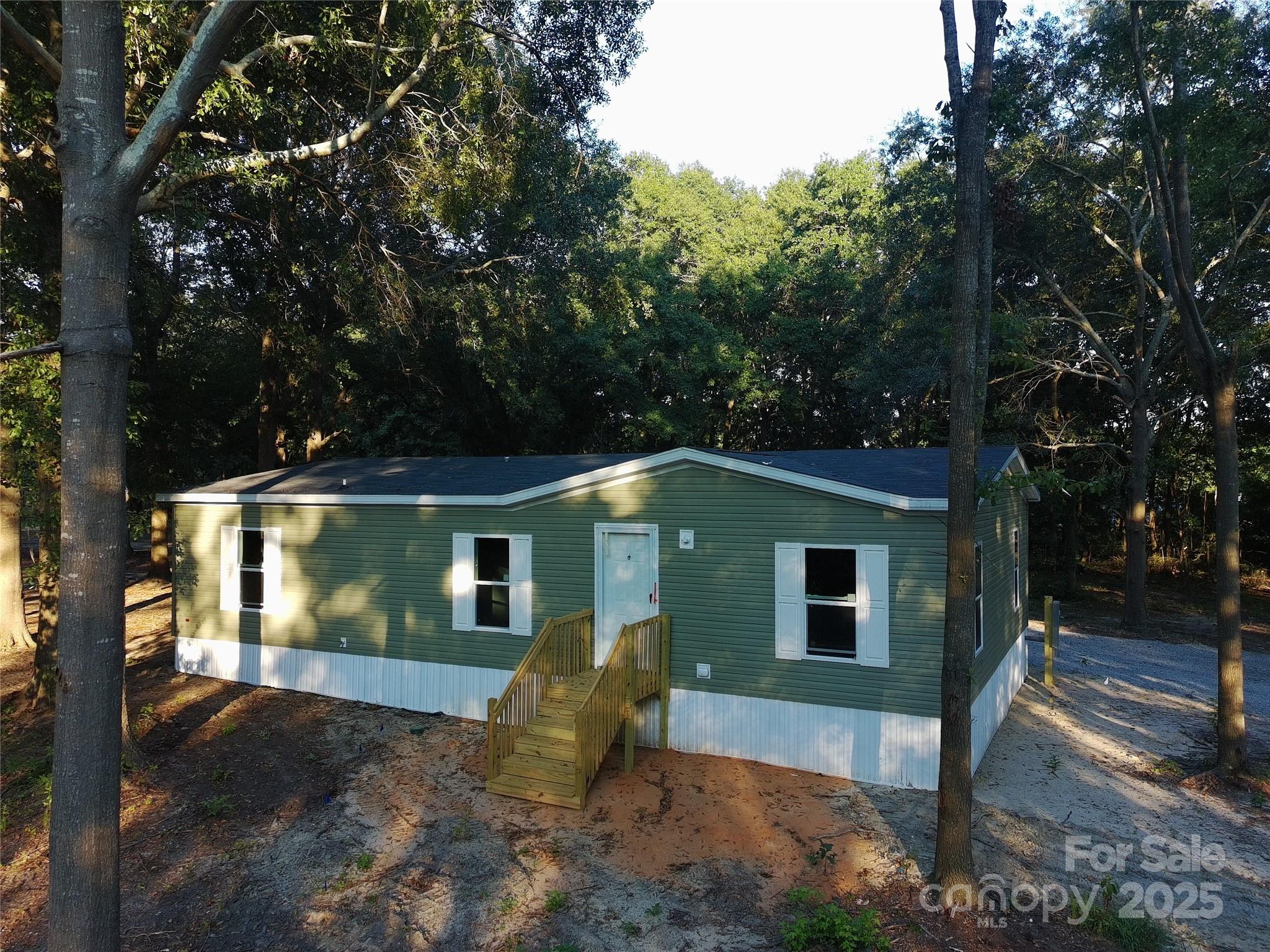 181 Duncan Road Pageland, SC 29728 - Photo 2 of 11 a front view of a house with garden