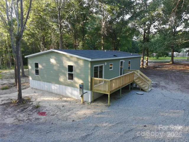 a backyard of a house with barbeque oven table and chairs