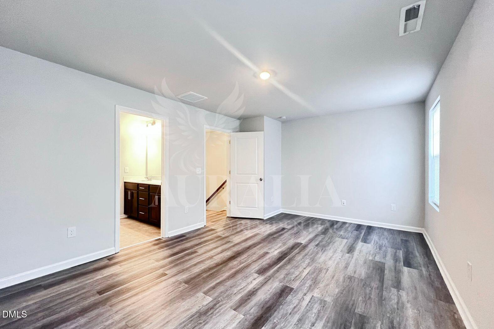 181 Ivy Vine Way Raleigh, NC 27610 - Photo 10 of 22 wooden floor in an empty room with a window