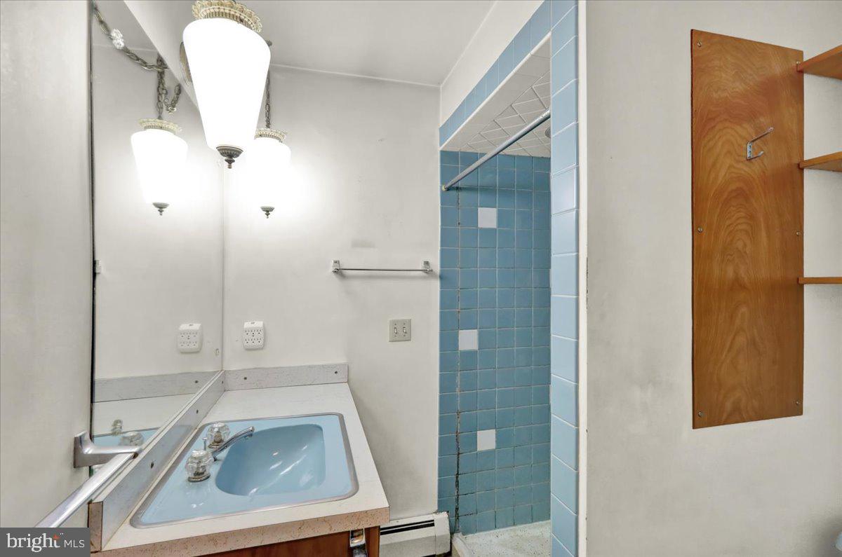 508 American Legion Boulevard Pine Grove, PA 17963 - Photo 15 of 40 a bathroom with a sink a mirror and shower