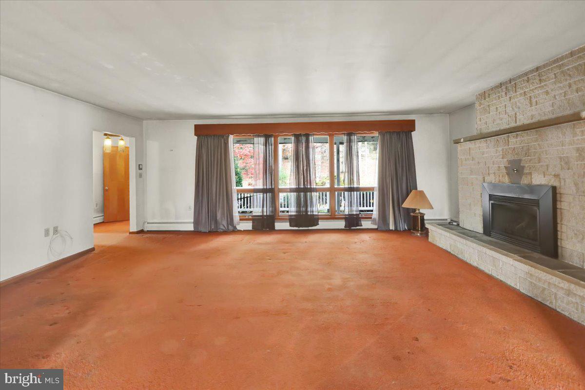 508 American Legion Boulevard Pine Grove, PA 17963 - Photo 19 of 40 an empty room with floor to ceiling window and fireplace
