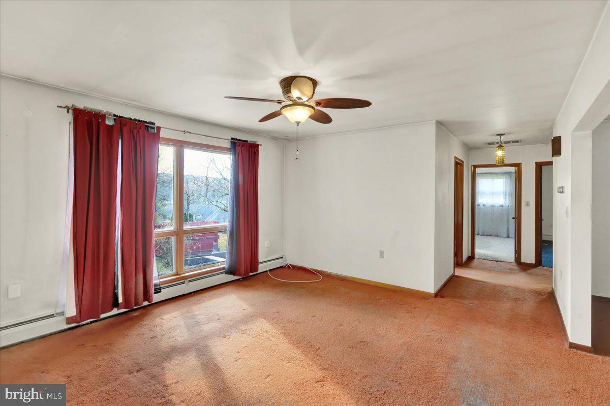 508 American Legion Boulevard Pine Grove, PA 17963 - Photo 23 of 40 an empty room with windows and chandelier fan