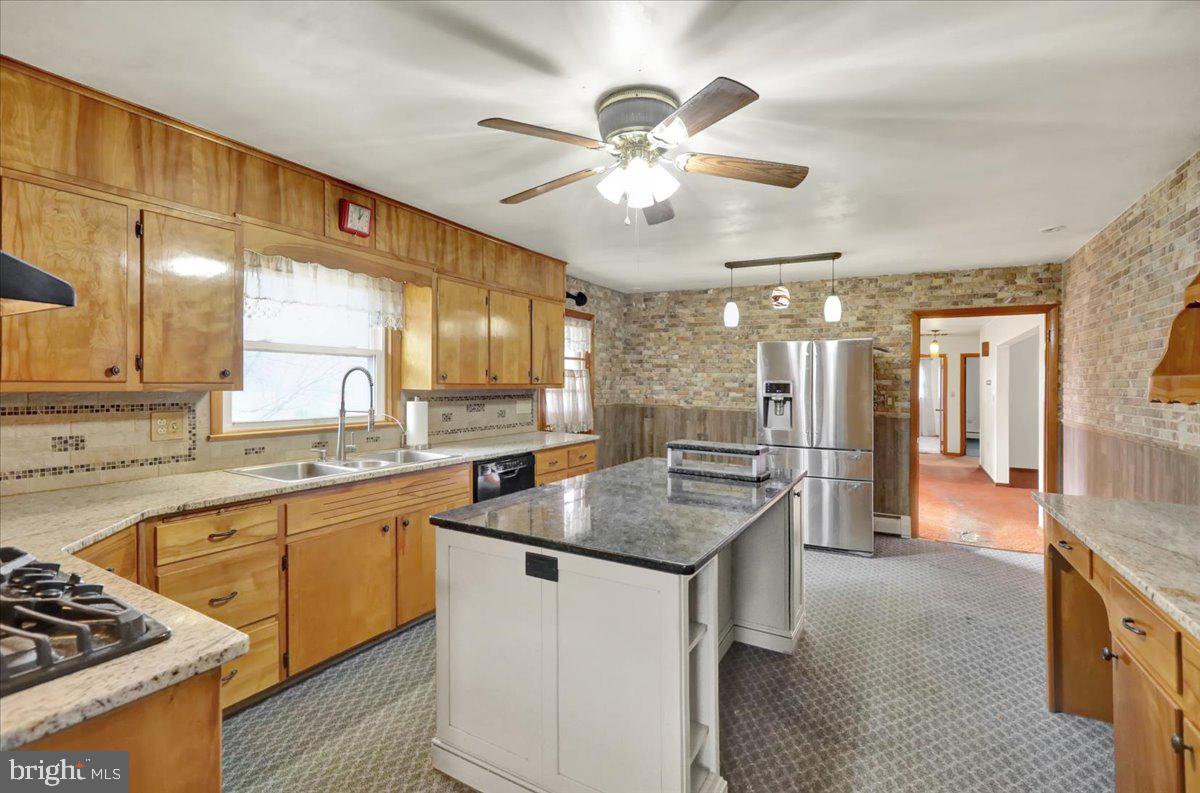 508 American Legion Boulevard Pine Grove, PA 17963 - Photo 6 of 40 a kitchen with a stove a sink a kitchen island with wooden cabinets and floor