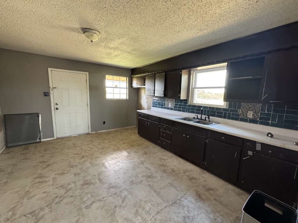 2605 East 19th Street Lubbock, TX 79403 - Photo 4 of 10 a large bathroom with a sink and a large mirror