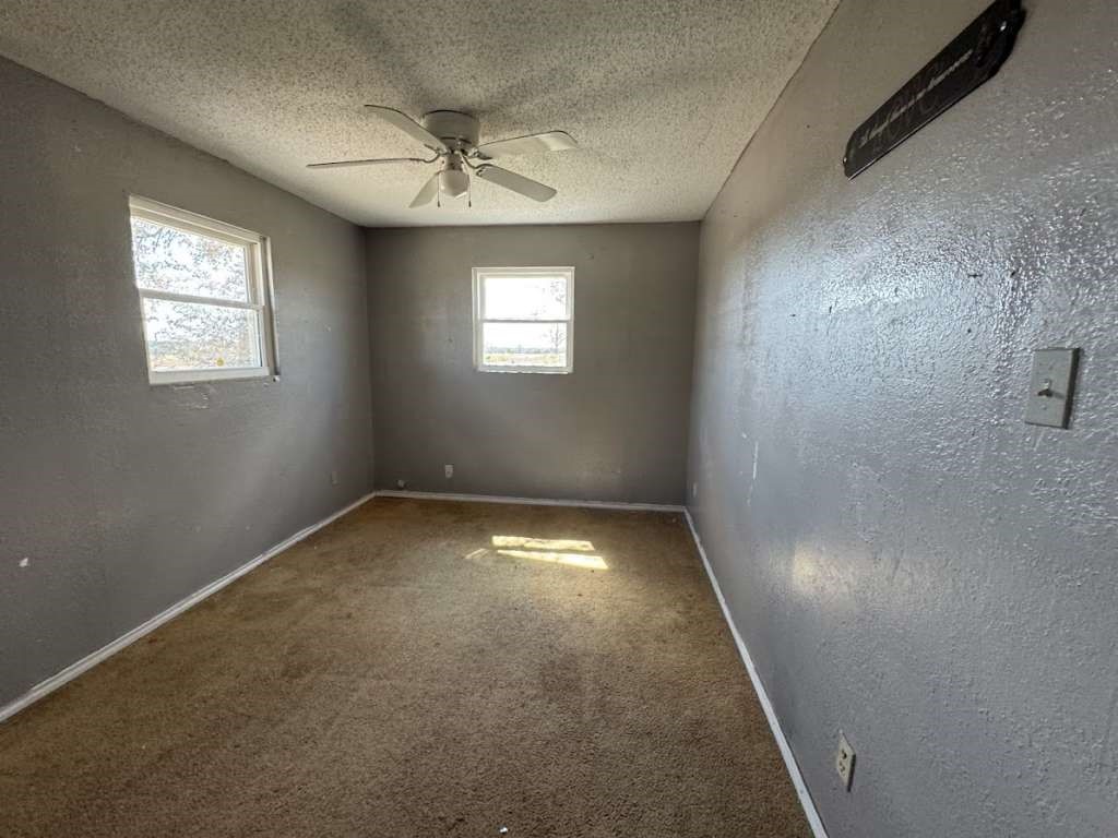 2605 East 19th Street Lubbock, TX 79403 - Photo 6 of 10 an empty room with a empty space and windows