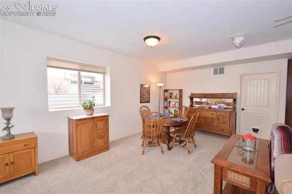 a dining room with furniture and window
