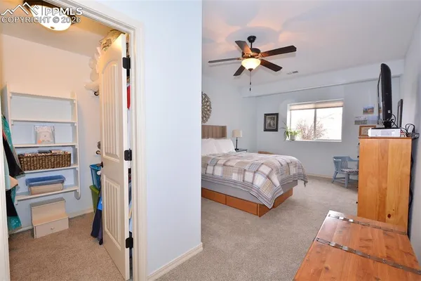 a bedroom with a bed and ceiling fan