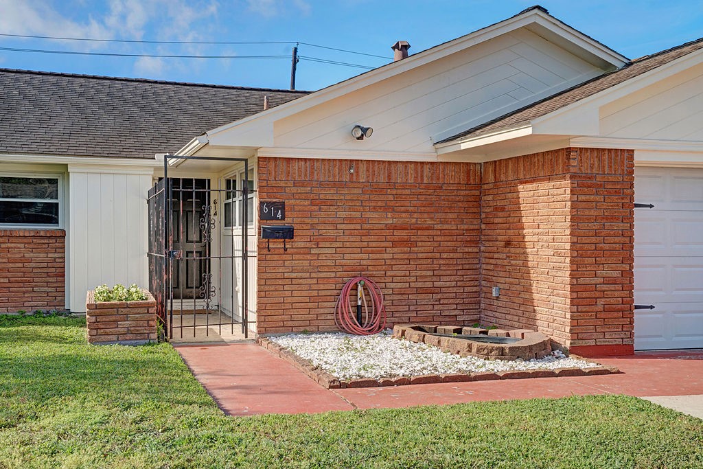 614 Gilpin Street Houston, TX 77034 - Photo 3 of 27 View of the home as you approach the front door featuring a low maintenance rock garden area and elevated brick planter.