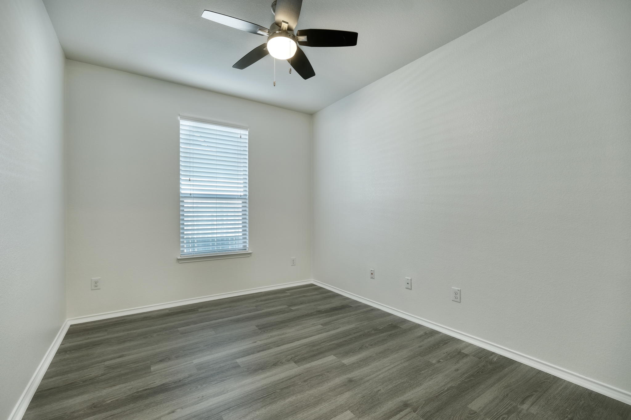 13813 James Garfield Street Manor, TX 78653 - Photo 6 of 13 wooden floor in an empty room with a window