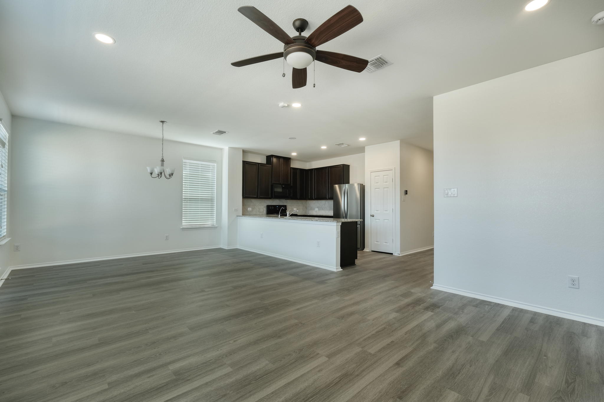 13813 James Garfield Street Manor, TX 78653 - Photo 8 of 13 a view of a kitchen with a sink and a refrigerator