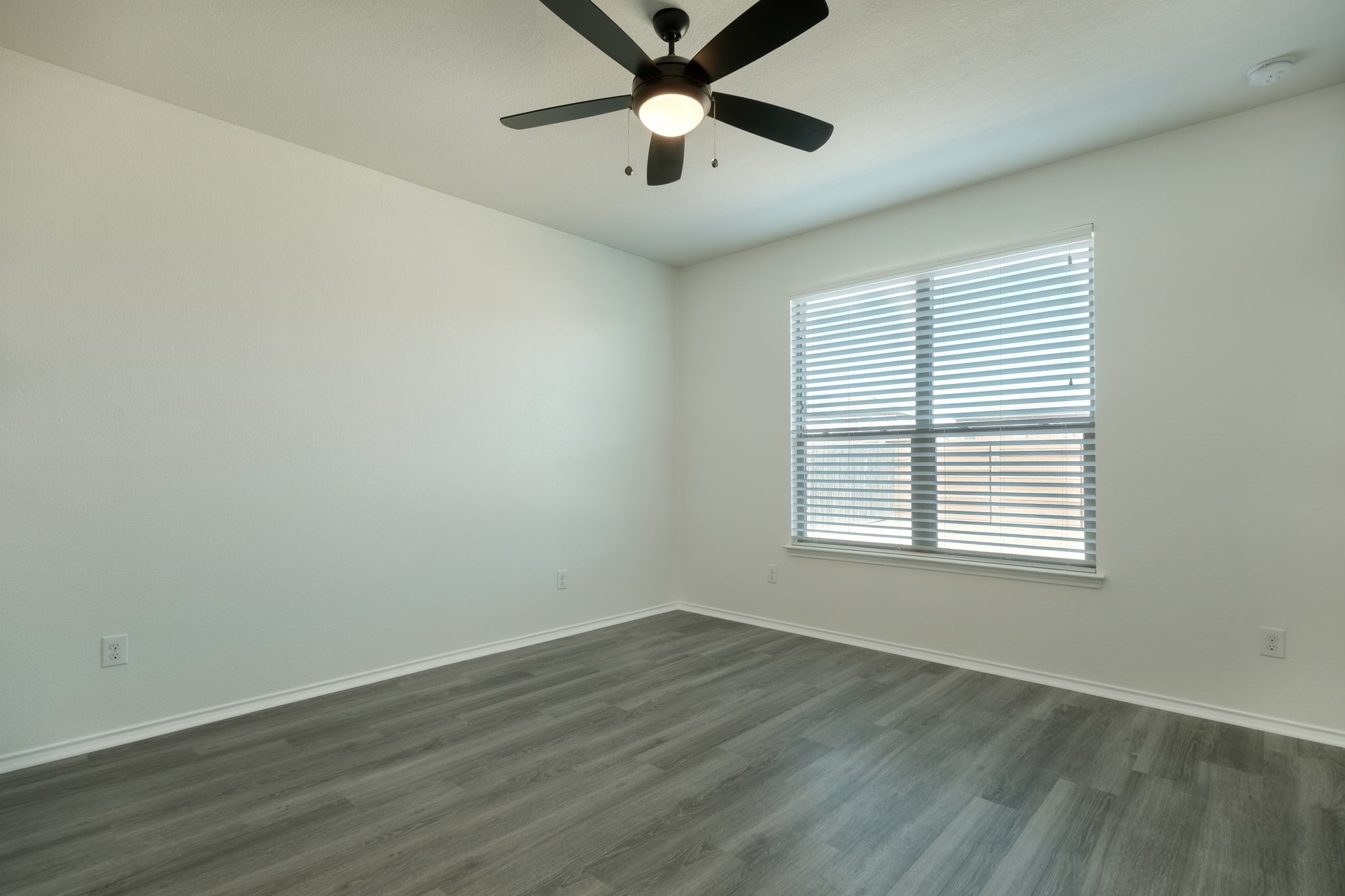 13813 James Garfield Street Manor, TX 78653 - Photo 10 of 13 wooden floor in an empty room with a window